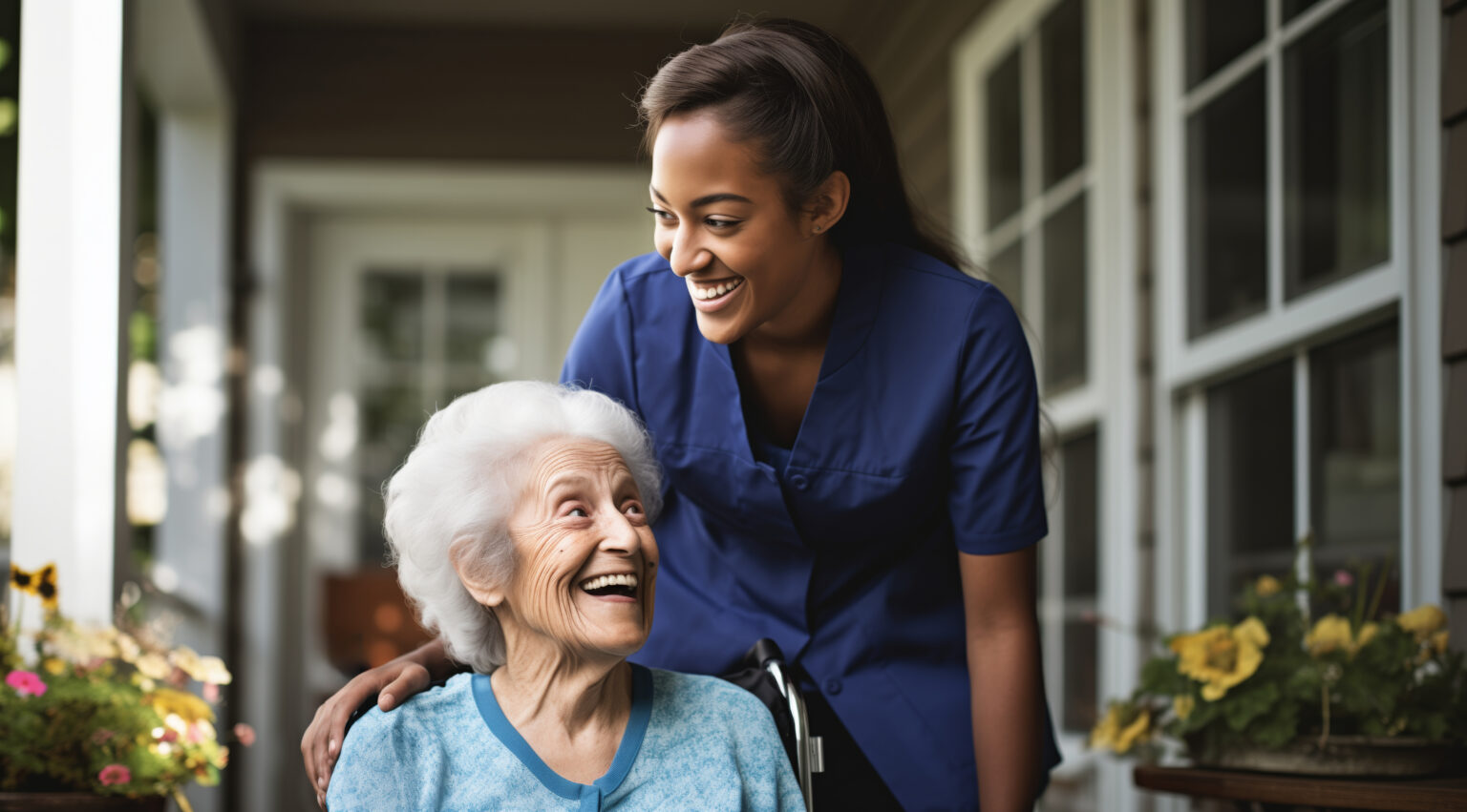 Caregiver smiling with an elderly client